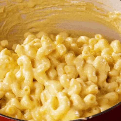 A Close Up Of Macaroni And Cheese In A Red Pot GIF