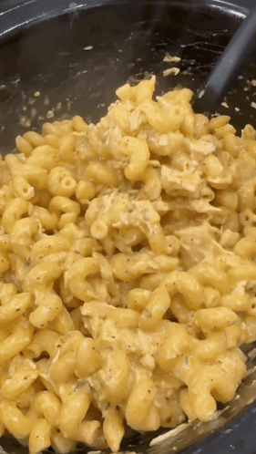 A Close Up Of Macaroni And Cheese With A Spoon In It GIF