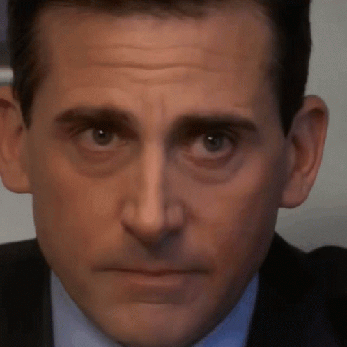 A Close Up Of Michael Scott 'S Face With A Serious Look On His Face GIF