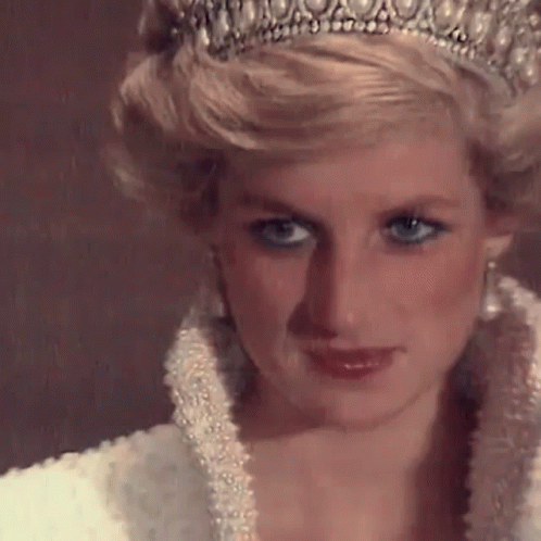 A Close Up Of Princess Diana Wearing A Tiara And A White Dress . GIF