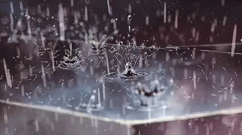 A Close Up Of Rain Drops Falling On A Table . GIF