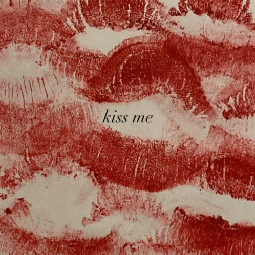 A Close Up Of Red Lips With The Words Kiss Me Written In White GIF