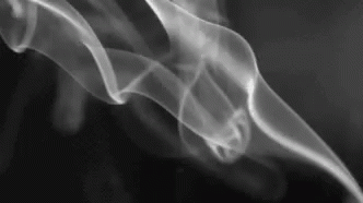 A Close Up Of Smoke Coming Out Of A Pipe On A Black Background . GIF