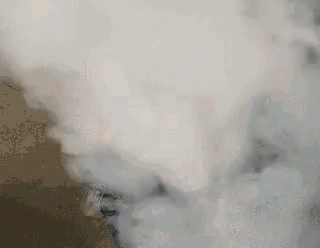 A Close Up Of Smoke Coming Out Of A Stove . GIF