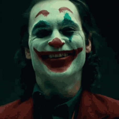 A Close Up Of The Face Of A Man Dressed As The Clown GIF