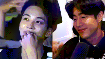 A Close Up Of Two Men 'S Faces , One Covering His Mouth With His Hand . GIF