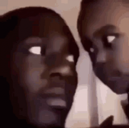 A Close Up Of Two People 'S Faces Looking At Each Other With Their Eyes Closed . GIF