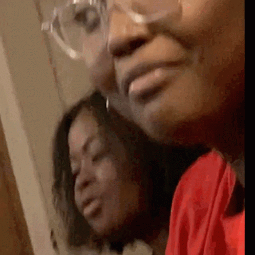 a close up of two women 's faces with glasses .