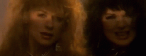A Close Up Of Two Women With Their Mouths Open . GIF