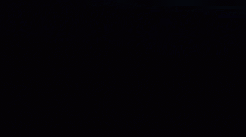 A Close Up Of Venom 'S Face With Sharp Teeth In The Dark . GIF
