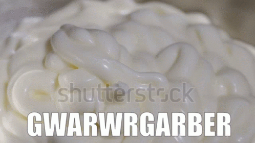 A Close Up Of Whipped Cream With The Words Gwarwrgarber On It GIF