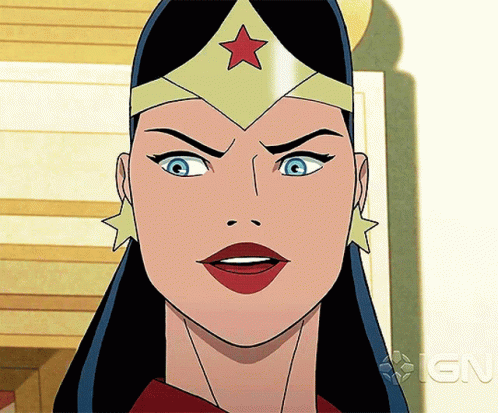 A Close Up Of Wonder Woman 'S Face With An Ign Logo In The Background GIF
