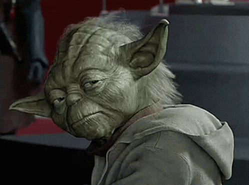 a close up of yoda wearing a hoodie with a sad look on his face