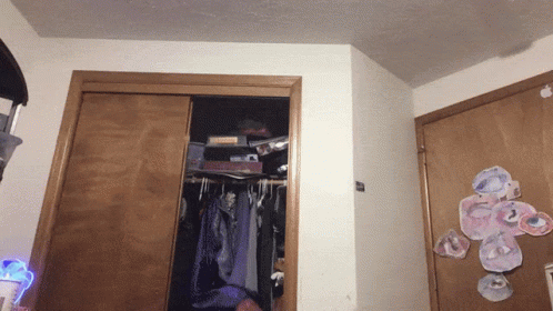 a closet with clothes hanging and a sticker on the door that says ' i love you '