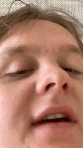 A Closeup Of A Man 'S Face With His Eyes Closed GIF