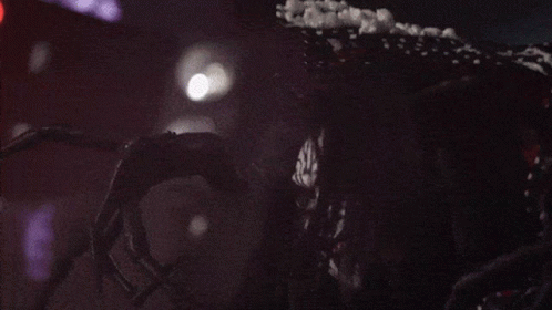A Clown With A Polka Dot Dress Is Laughing With His Mouth Open GIF