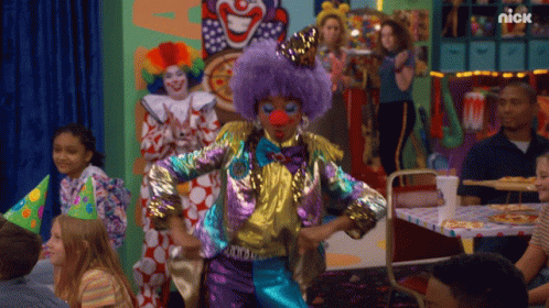 A Clown With A Purple Wig And Red Nose Is Dancing In Front Of A Nick Sign GIF