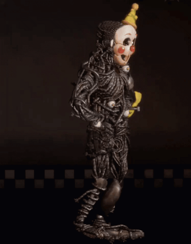 A Clown With A Yellow Hat Is Holding A Yellow Item GIF