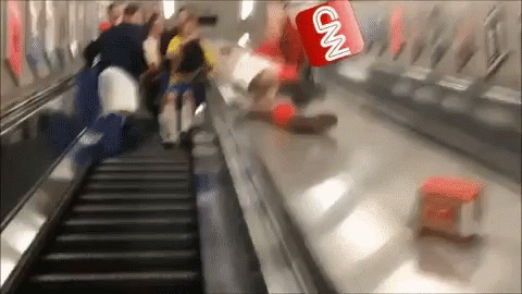 A Cnn Logo Is Flying Over A Group Of People Riding An Escalator GIF