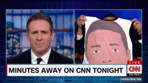 A Cnn News Report Shows A Man Holding A Shirt With A Picture Of A Man On It GIF