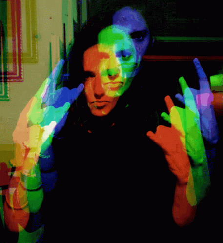 A Colorful Image Of A Person Making A Horns Sign GIF