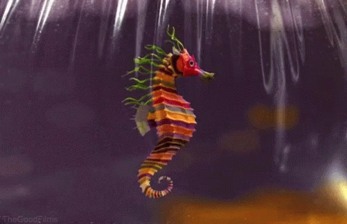 A Colorful Seahorse With A Red Head And Green Tails GIF