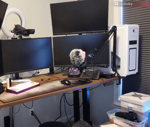 A Computer Desk With Two Monitors And A Microphone And A Screen That Says Cality On It GIF