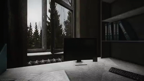 A Computer Is Sitting On A Desk In Front Of A Window In A Dark Room . GIF