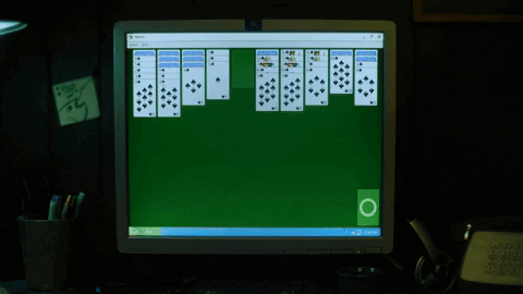 A Computer Monitor Displaying A Game Of Solitaire GIF