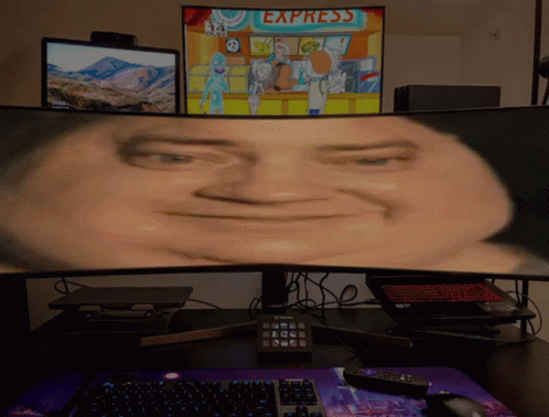 A Computer Monitor Shows A Man 'S Face In Front Of A Sign For Express GIF