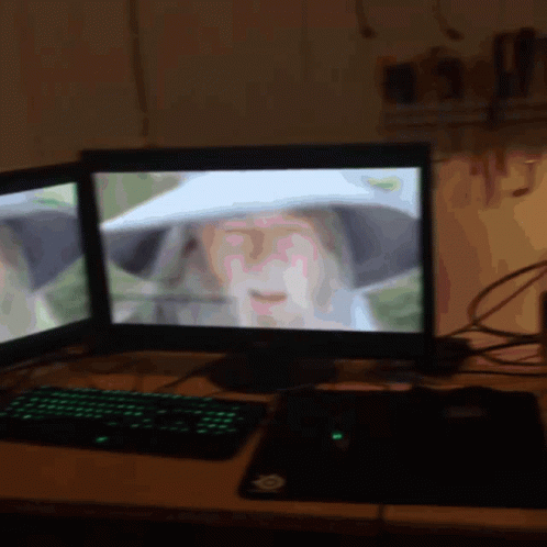 A Computer Monitor Shows A Woman Wearing A White Hat GIF
