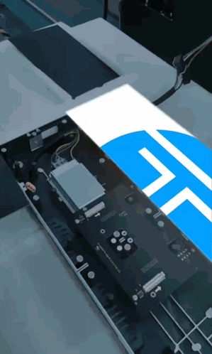 a computer motherboard with a blue and white t on it