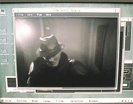 A Computer Screen Shows A Man In A Hat And Gloves GIF