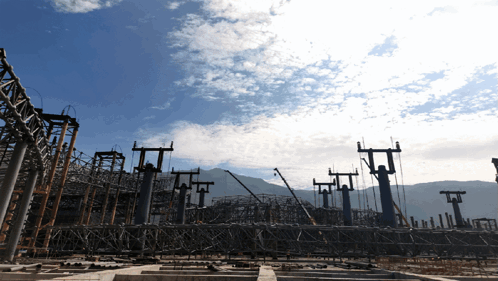 A Construction Site With A Blue Sky Behind It GIF