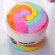A Container Of Rainbow Bagel Slime With A Swirl In The Middle GIF