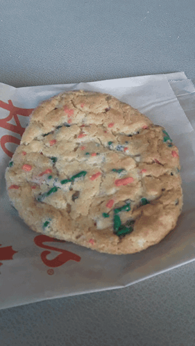 A Cookie Is Sitting On A Piece Of Paper That Says ' Chick-Fil-A ' GIF