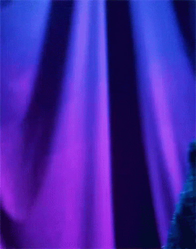 A Cookie Monster Is Standing In Front Of A Blue Curtain GIF