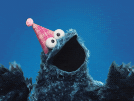 A Cookie Monster Wearing A Pink Party Hat Looks Up At The Sky GIF