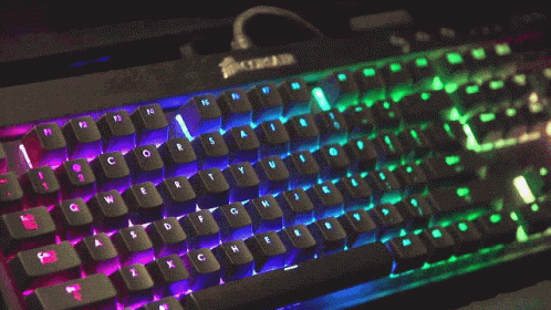 A Corsair Keyboard Has A Rainbow Of Lights On The Keys GIF