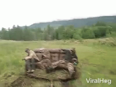 A Couch Is Sitting In The Middle Of A Field . GIF