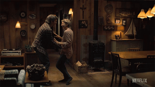A Couple Dancing In A Living Room With A Netflix Logo On The Bottom GIF