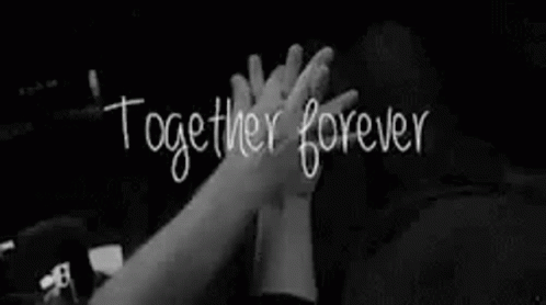a couple is holding hands in a black and white photo with the words `` together forever '' written on it .