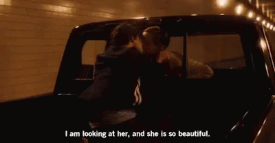 A Couple Is Kissing In The Back Of A Truck . GIF