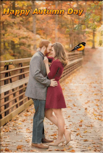 A Couple Kissing On A Bridge With The Words Happy Autumn Day GIF