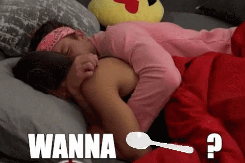 A Couple Laying In Bed With The Word Wanna On The Bottom Right GIF