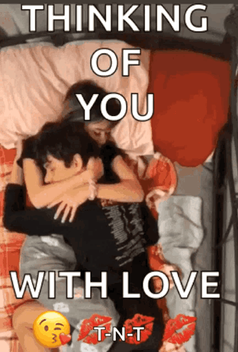 a couple laying on a bed with the words " thinking of you with love " on the bottom