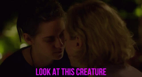 A Couple Looking Into Each Other 'S Eyes With The Caption Look At This Creature GIF