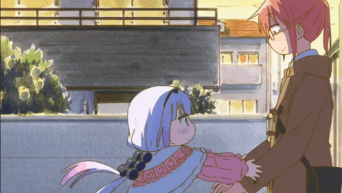 a couple of anime characters standing next to each other with one of them wearing a sweater with the letter o on it