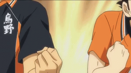 A Couple Of Anime Characters Standing Next To Each Other With Their Fist In The Air . GIF