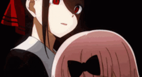 A Couple Of Anime Girls Are Standing Next To Each Other And Looking At Each Other . GIF
